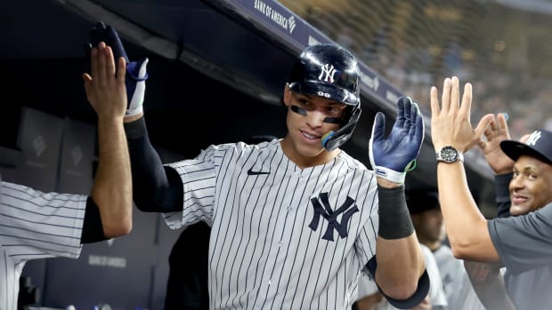 Sep 20, 2022; Bronx, New York, USA; New York Yankees right fielder Aaron Judge (99) celebrates his 60th home run of the season with teammates in the dugout during the ninth inning against the Pittsburgh Pirates at Yankee Stadium. Mandatory Credit: Brad Penner-USA TODAY Sports